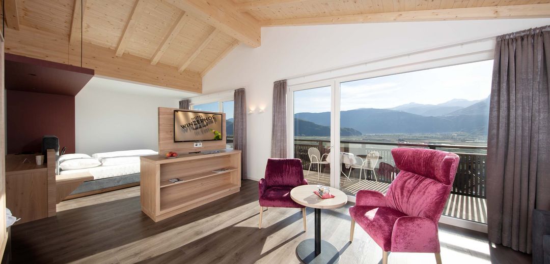 Junior suite sitting area TV double bed view South Tyrolean Etschland